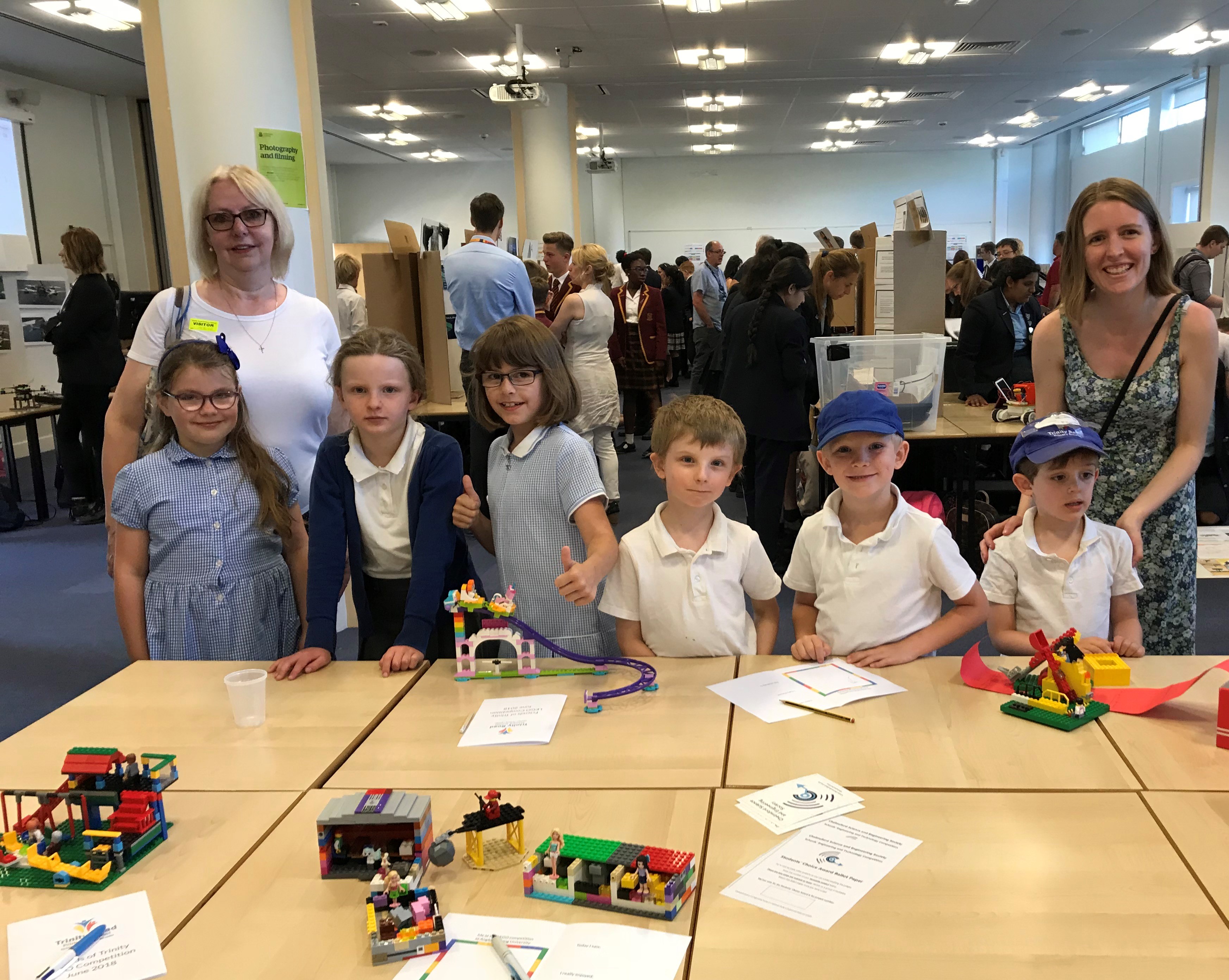 Children from Trinity Road Primary School proudly display their entries for the CSES competition at Anglia Ruskin University