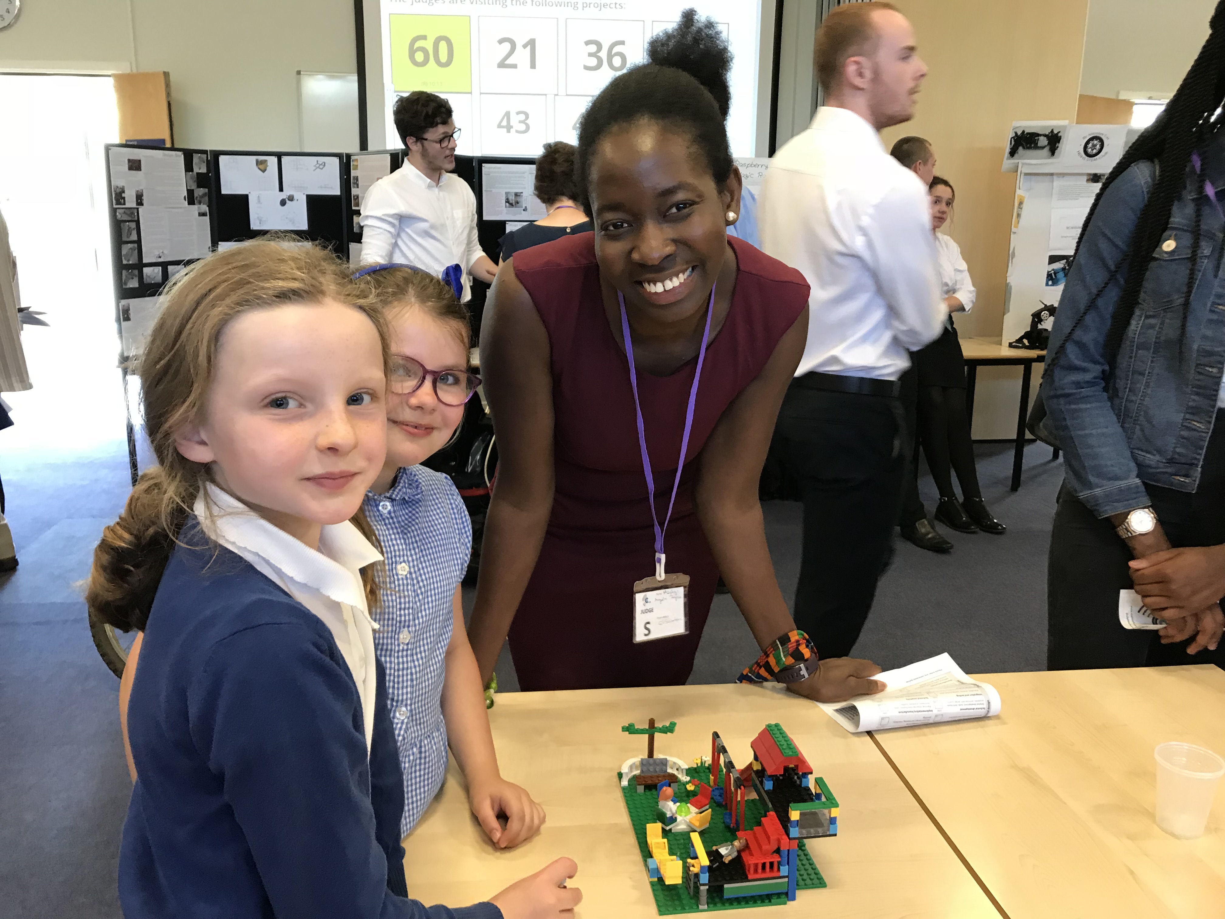 Competition judge Hephzi Angela Tagoe speaks with primary school pupils Erika and Rose