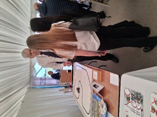A CSES volunteer talking to a student at the Braintree Careers Fair 2025