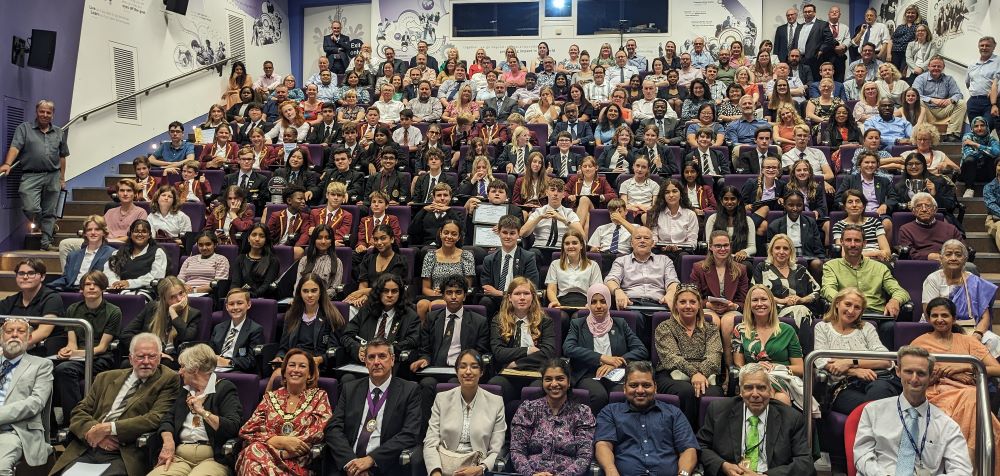 Students, teachers and parents sitting in a lecture hall at a CSES event at ARU